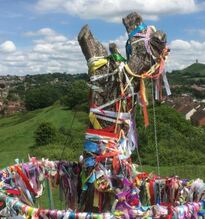 Stump of the Glastonbury Holy Thorn Tree covered in ribbons